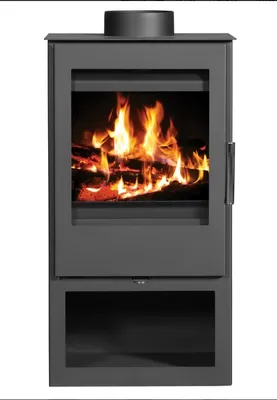 A dark gray wood-burning stove with a glass door showing a fire inside, set against a white background.