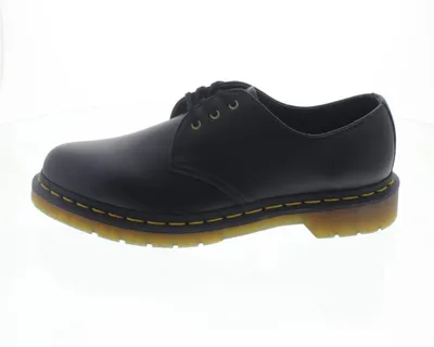 A side view of a black Dr. Martens shoe against a white background.