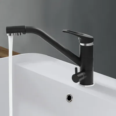A black kitchen faucet with water running into a white sink.