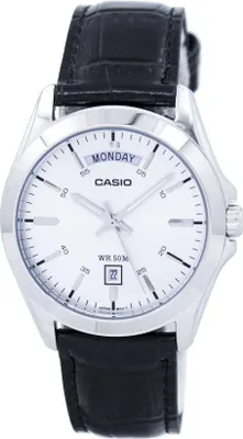 A close-up studio shot of a Casio watch with a white face and black leather strap.
