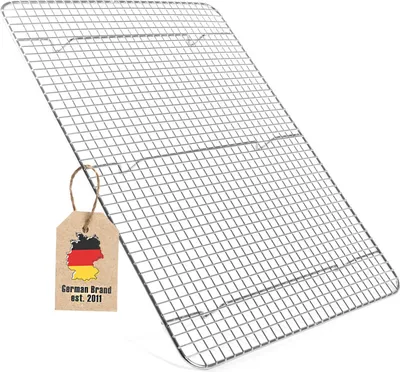 A silver metal cooling rack is shown at an angle against a white background. A small brown tag with the German flag and text is attached to the rack.