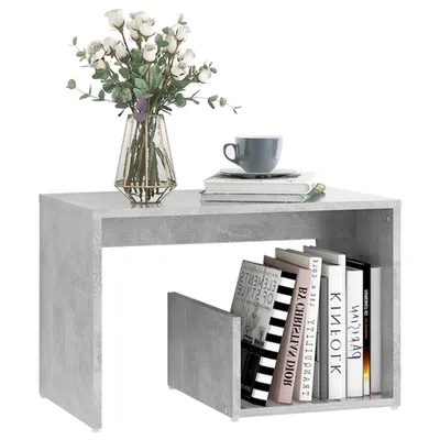 A modern side table with books and a vase of flowers.