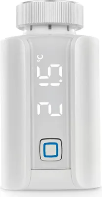 A white smart thermostat with a digital display showing temperature.