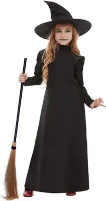 A young girl dressed as a witch, holding a broomstick.