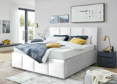 A bedroom scene with a bed as the main focus.