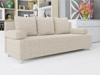 A beige sofa with three cushions is shown in a well-lit room with shelves in the background.