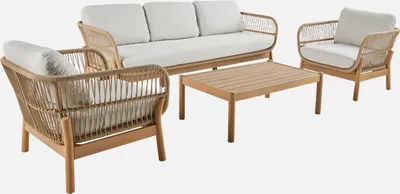 A set of outdoor furniture including a sofa, two armchairs, and a coffee table, all with a natural wood frame and woven rope detailing, and white cushions.