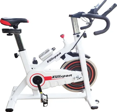 A white stationary bicycle with black and red accents, shown against a plain white background.
