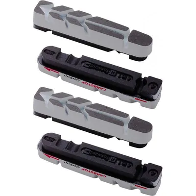 Four bicycle brake pads are arranged in a stack against a white background.