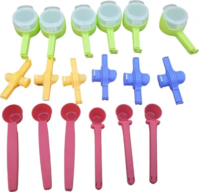 A collection of plastic bag clips and measuring spoons arranged in rows on a white background.