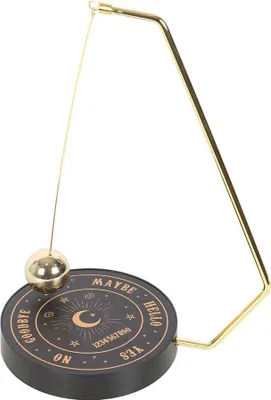 A pendulum dowsing board with a gold pendulum.
