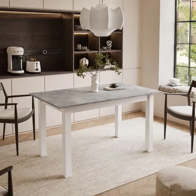 A dining table and chairs in a modern kitchen setting.