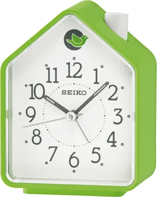A green house-shaped alarm clock with a white face and black hands.