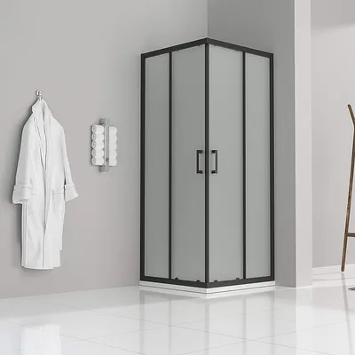 A modern bathroom with a shower cabin, a bathrobe hanging on the wall, and a towel rack.
