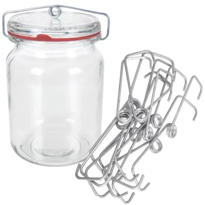 A glass jar with a wire bail lid and a red rubber seal, next to a pile of metal spring clips.