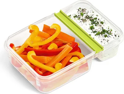 A clear, well-lit studio shot of a food container with cut vegetables and dip.