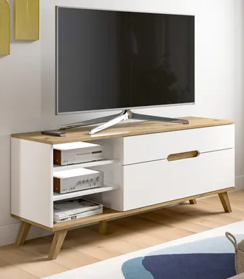 A TV lowboard with a television on top, placed in a room setting.