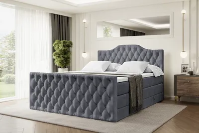 A bedroom scene with a large upholstered bed as the main focus.