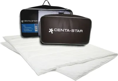 A white duvet is laid out in front of two branded bags, one black and one brown, on a white background.