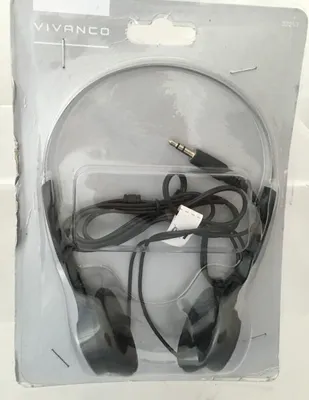 A pair of black headphones in their original packaging.