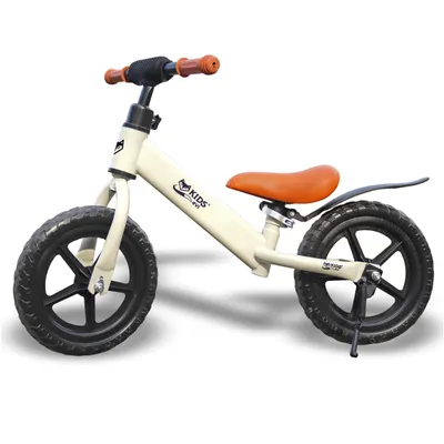 A cream-colored balance bike for children with orange handlebars and seat, shown against a white background.