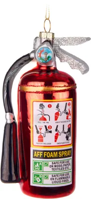 A close-up studio shot of a glass Christmas ornament shaped like a red fire extinguisher.