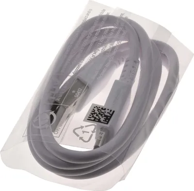 A white Samsung USB-A to USB-C cable is neatly coiled and placed inside its clear plastic packaging.