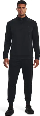 A man wearing a black Under Armour sweatshirt and sweatpants, standing and facing the camera.