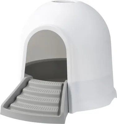 A white and gray igloo-shaped cat litter box with a set of stairs leading to the entrance.