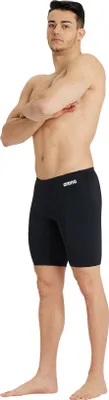 A man wearing black swim shorts.