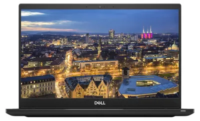 A laptop computer is shown from the front with its screen displaying a cityscape at dusk.