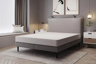 A bedroom scene with a bed and bedside tables.