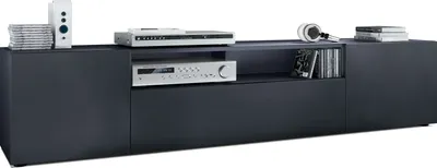 A modern, dark gray TV stand with electronic components and media on display.