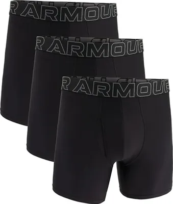 Three black boxer shorts are stacked on a white background.