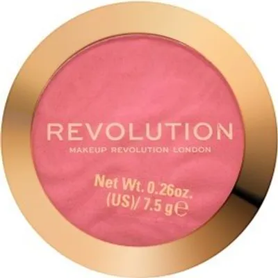A top-down view of a round makeup compact with pink powder blush inside and a gold rim.