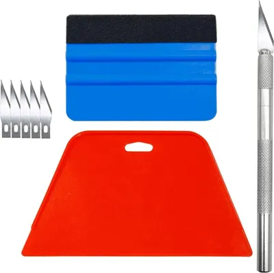 A set of tools for applying vinyl film, including a squeegee, utility knife, and blades, laid out on a white background.