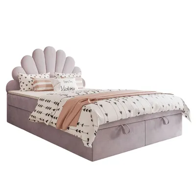 A bed with a unique shell-shaped headboard, dressed in bedding with a heart and arrow pattern, and a pink throw blanket.