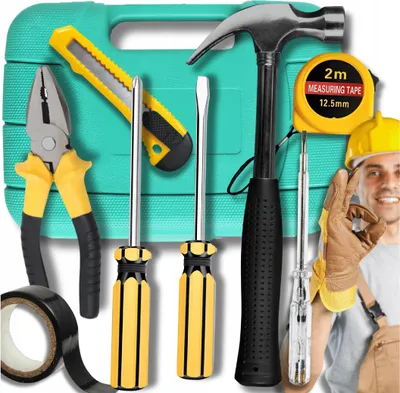 A collection of tools laid out in front of a teal toolbox, with a worker in the background.