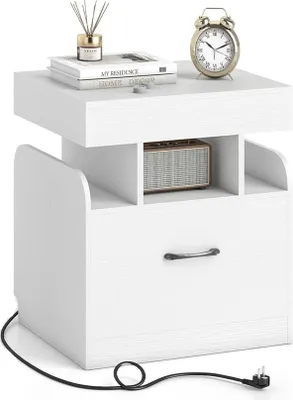 A white nightstand with a drawer and open shelves, featuring a clock and books on top.