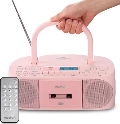 A pink Medion boombox with a remote control, held by a hand.