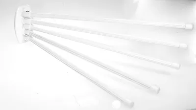 A white towel rack with five arms is shown against a white background.