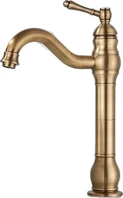 A close-up studio shot of a single antique brass faucet against a white background.