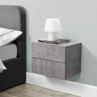 A modern bedroom setting with a wall-mounted nightstand next to a bed.