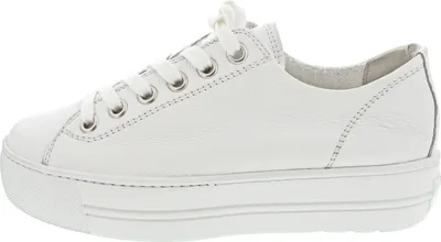 A side view of a white leather sneaker with a platform sole.