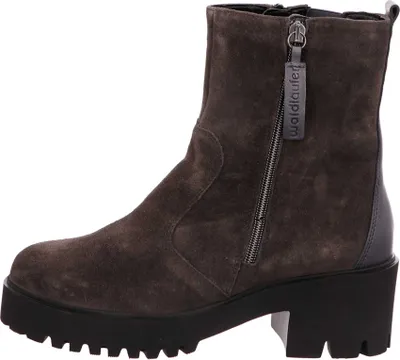 A side view of a brown suede boot with a thick black sole and a zipper.