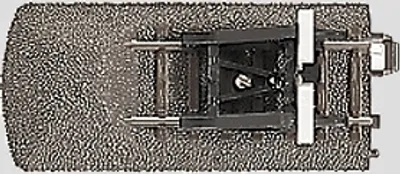 A top-down view of a model train track buffer stop.