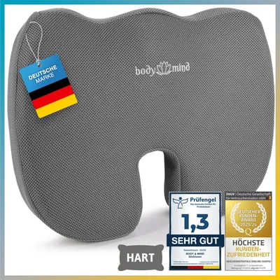 A gray orthopedic seat cushion with various certification badges and a German flag tag.