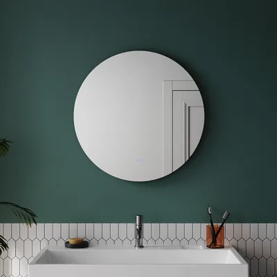 A round bathroom mirror with LED lighting above a sink with a faucet, toothbrush holder, and soap.