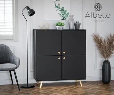 A modern living room scene featuring a black cabinet with gold accents, a floor lamp, a chair, and decorative items.