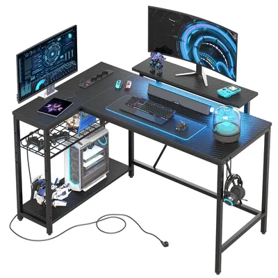 A gaming desk setup with multiple monitors, a computer tower, and gaming accessories.